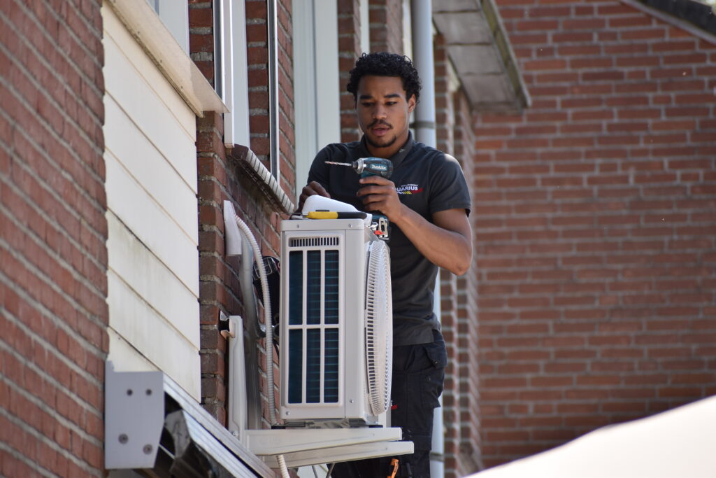 Monteur van Installatiebedrijf Aquarius installeert een airco in Sleeuwijk